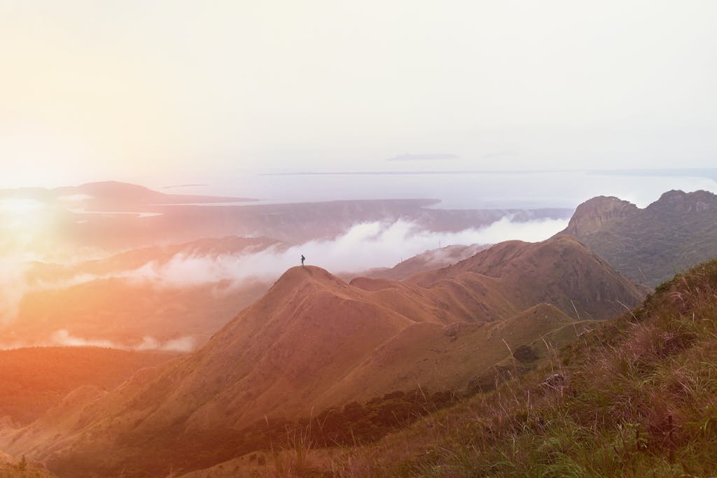 Dramatic sunset over the hills of Panamá with a lone traveler exploring the ridge.